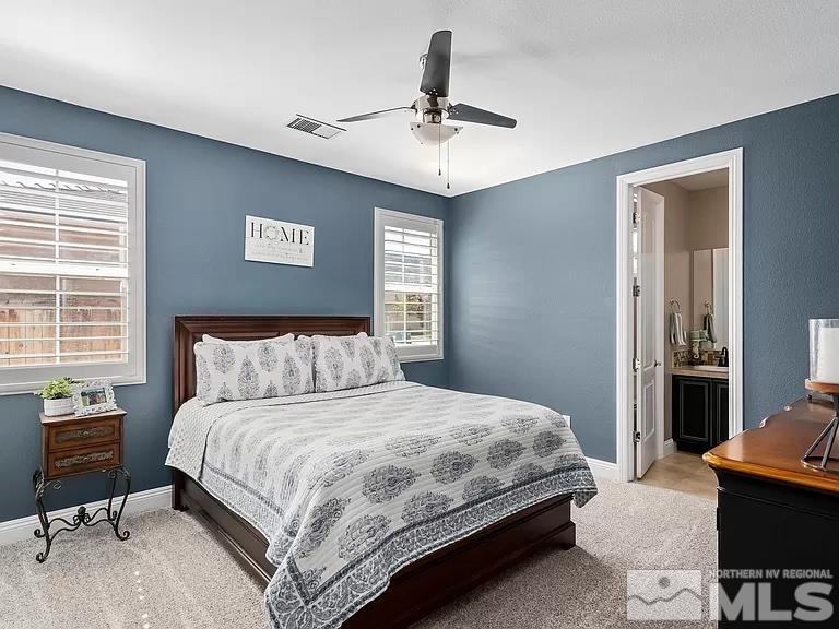 2725 Foxhunter Lane Reno, NV 89521 - Photo 18 of 25 a bedroom with a bed and a table in it