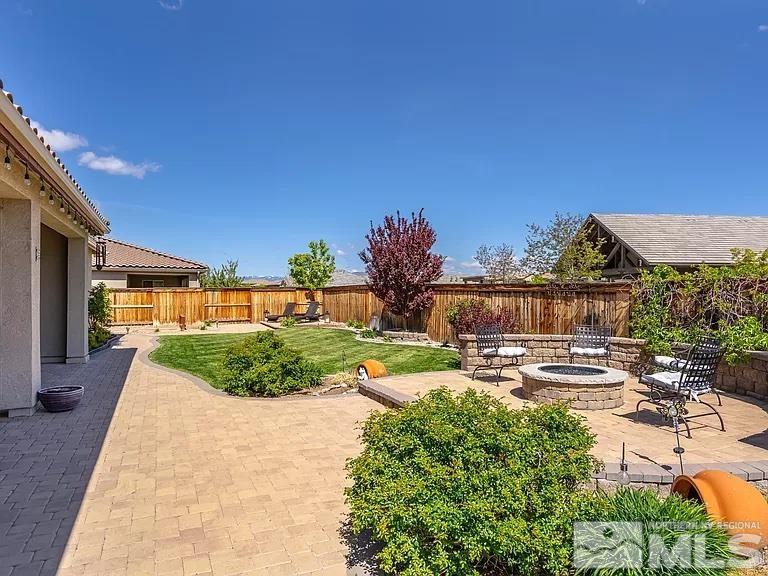 2725 Foxhunter Lane Reno, NV 89521 - Photo 22 of 25 a view of a patio with a table and chairs under an umbrella
