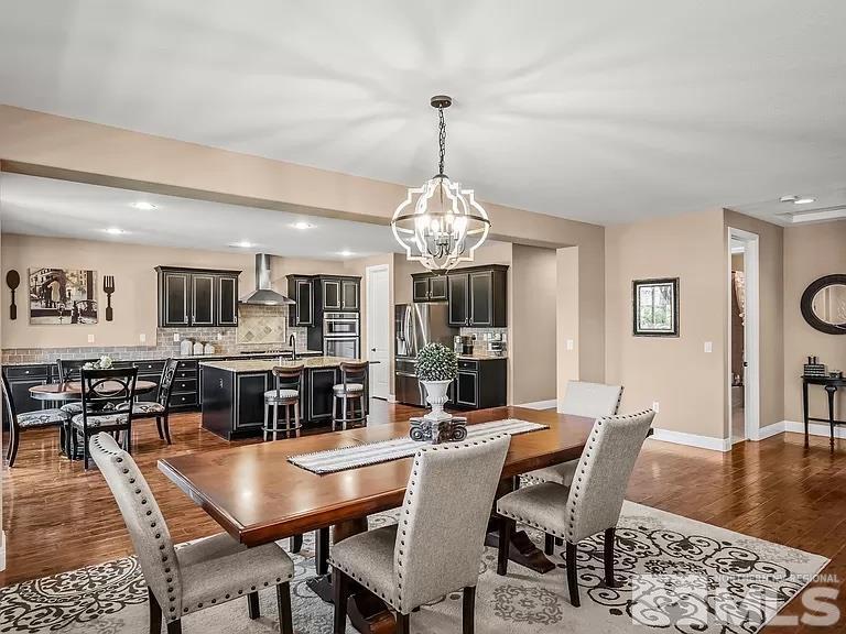 2725 Foxhunter Lane Reno, NV 89521 - Photo 4 of 25 a view of a dining room with furniture and wooden floor