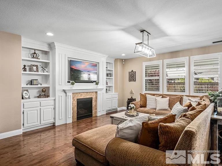 2725 Foxhunter Lane Reno, NV 89521 - Photo 5 of 25 a living room with furniture a fireplace and a flat screen tv