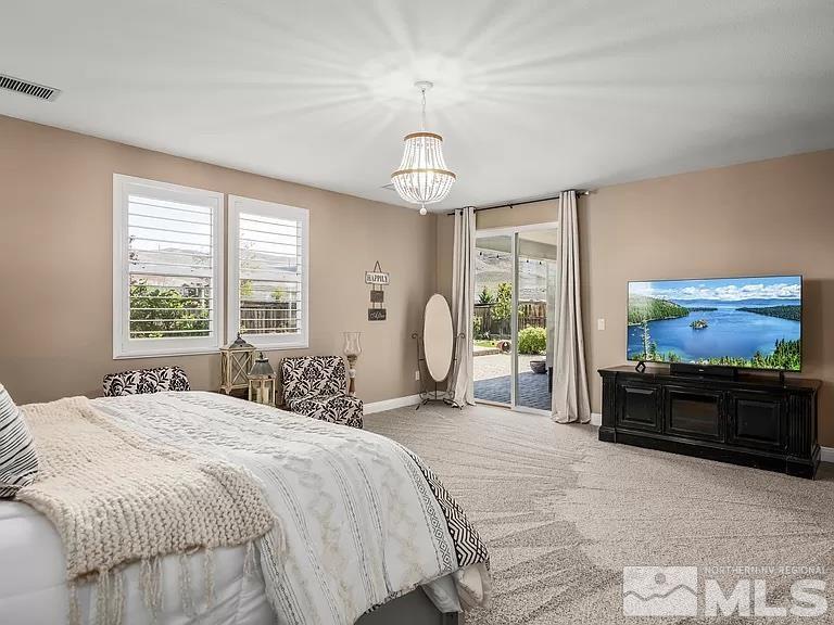 2725 Foxhunter Lane Reno, NV 89521 - Photo 9 of 25 a spacious bedroom with a bed and a flat screen tv