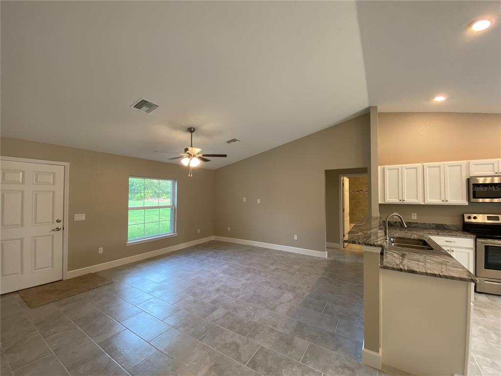 3011 Southwest 140th Loop Ocala, FL 34473 - Photo 2 of 22 a view of cabinets and kitchen with a sink