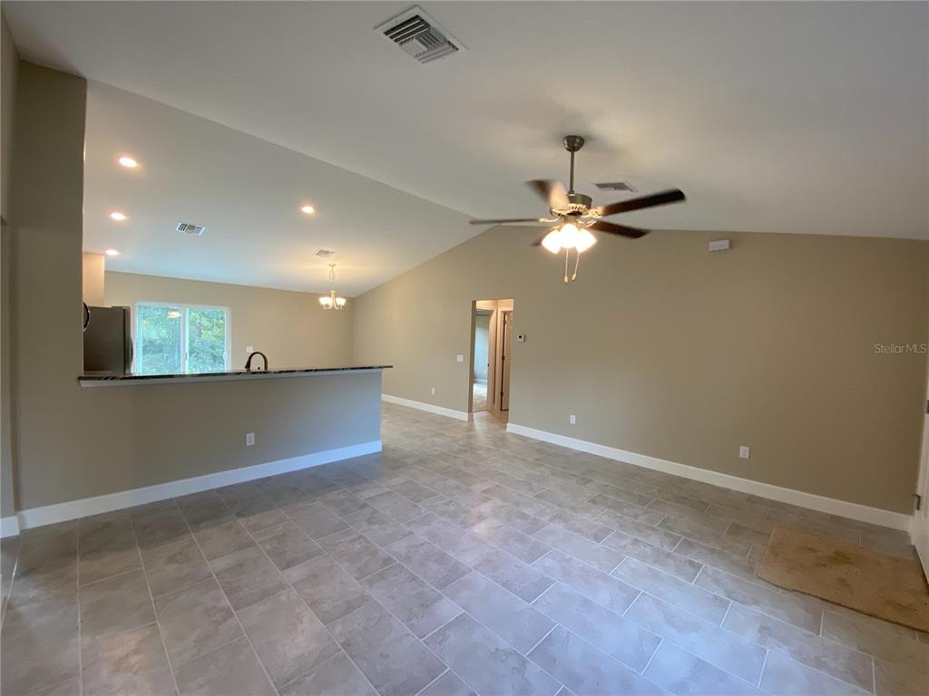 3011 Southwest 140th Loop Ocala, FL 34473 - Photo 3 of 22 a view of an empty room with a ceiling fan
