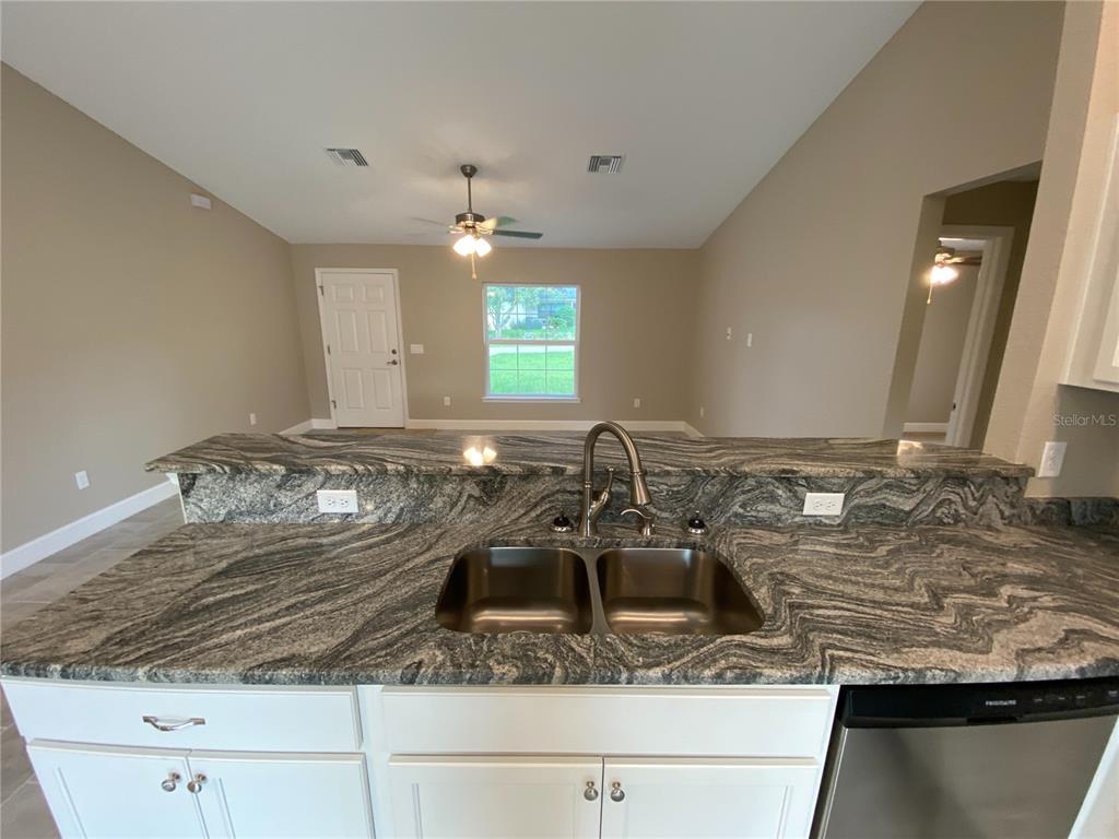 3011 Southwest 140th Loop Ocala, FL 34473 - Photo 6 of 22 a bathroom with a granite countertop sink and a mirror