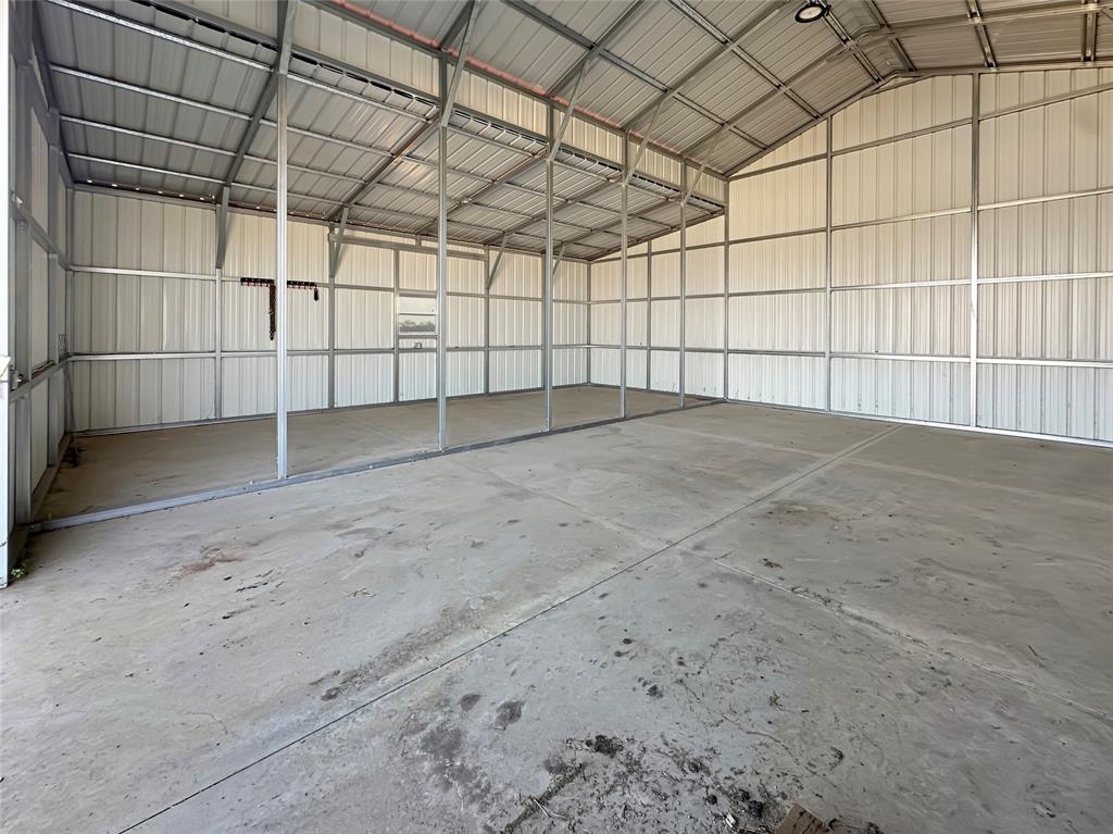 501 County Road 501 Blue Ridge, TX 75424 - Photo 9 of 27 Open interior layout featuring reinforced metal walls, exposed structural supports, and ample vertical clearance for large equipment or trailers.