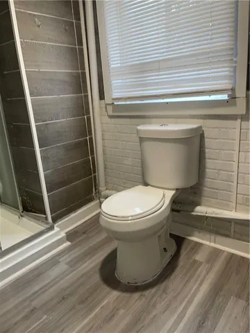 a bathroom with a toilet and a shower