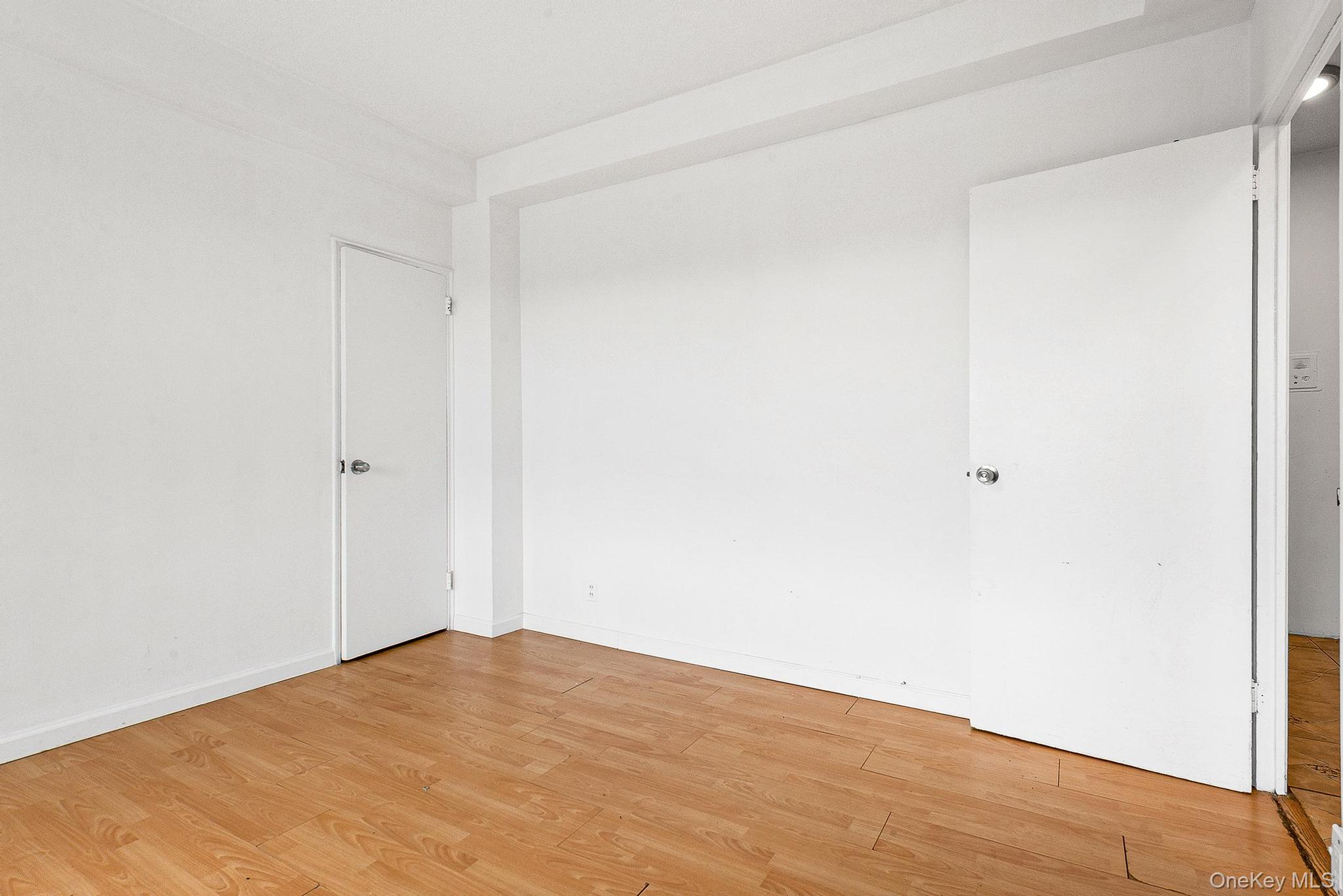 99-32 66th Road, Unit 5B Queens, NY 11374 - Photo 22 of 27 Empty room featuring light wood-style floors and baseboards