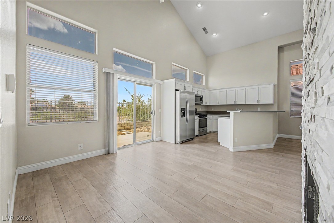 2316 Ramsgate Drive Henderson, NV 89074 - Photo 28 of 28 An open floorplan seamlessly connects the kitchen and living areas, offering effortless indoor-outdoor flow.