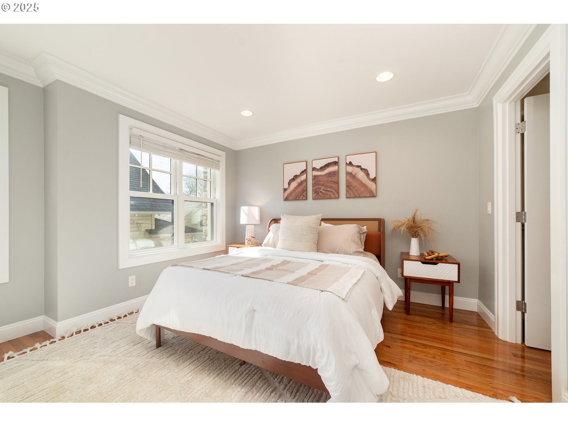 623 Northeast Randall Avenue Portland, OR 97232 - Photo 13 of 26 a bedroom with a bed and wooden floor
