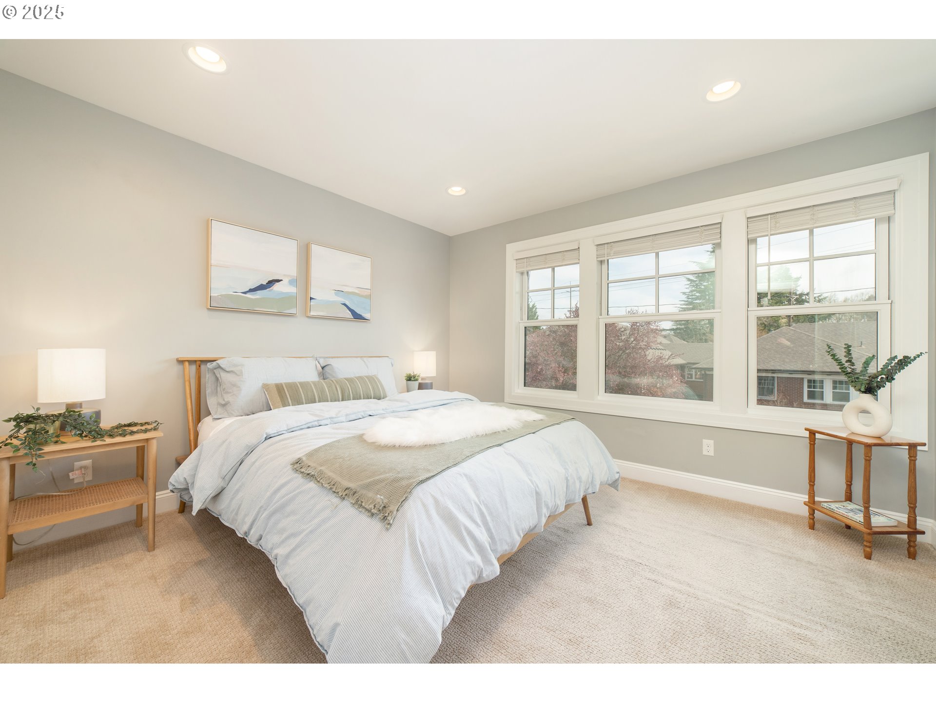 623 Northeast Randall Avenue Portland, OR 97232 - Photo 17 of 26 a spacious bedroom with a large bed and a large window