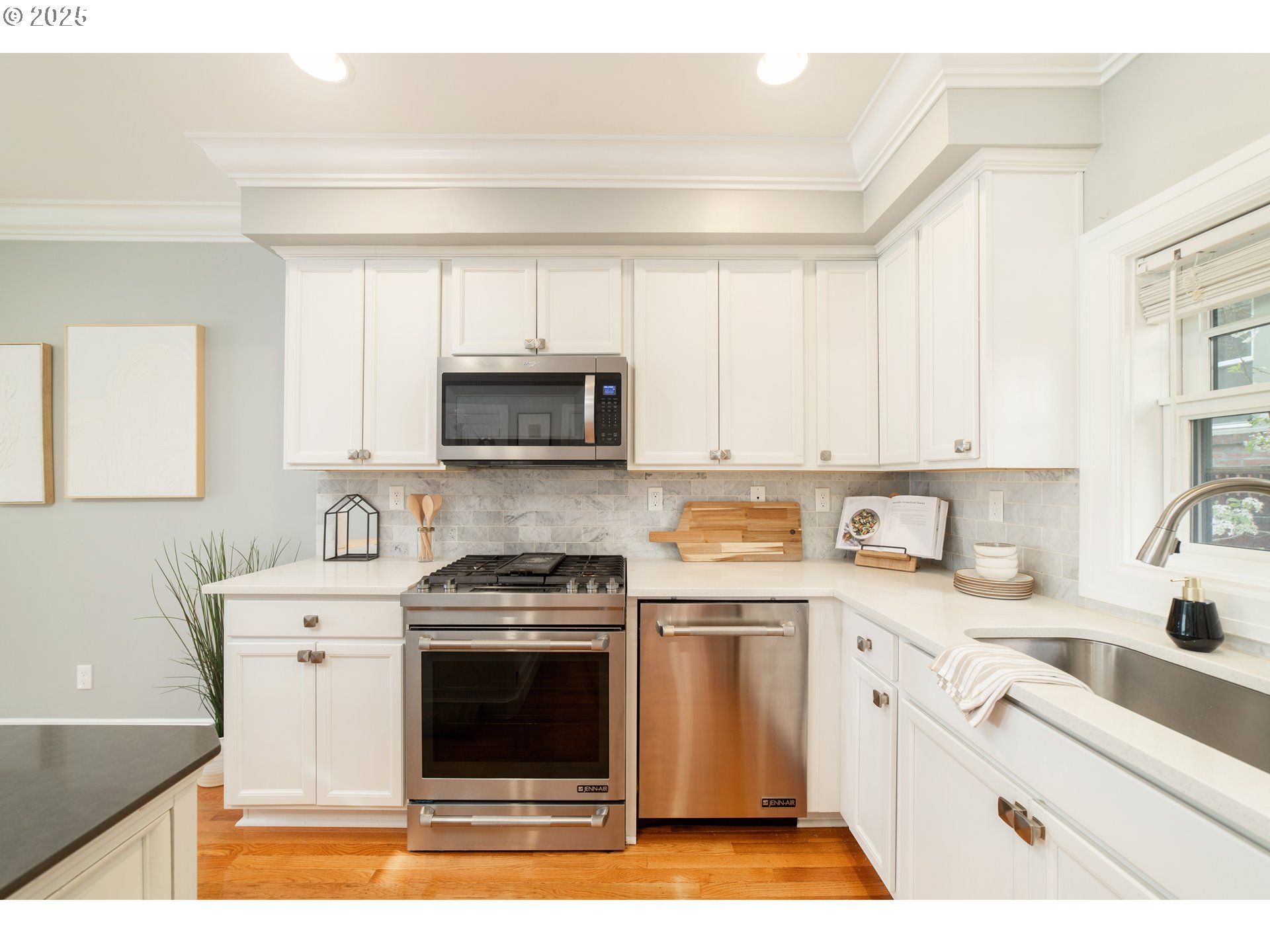 623 Northeast Randall Avenue Portland, OR 97232 - Photo 6 of 26 a kitchen with a sink stove and microwave