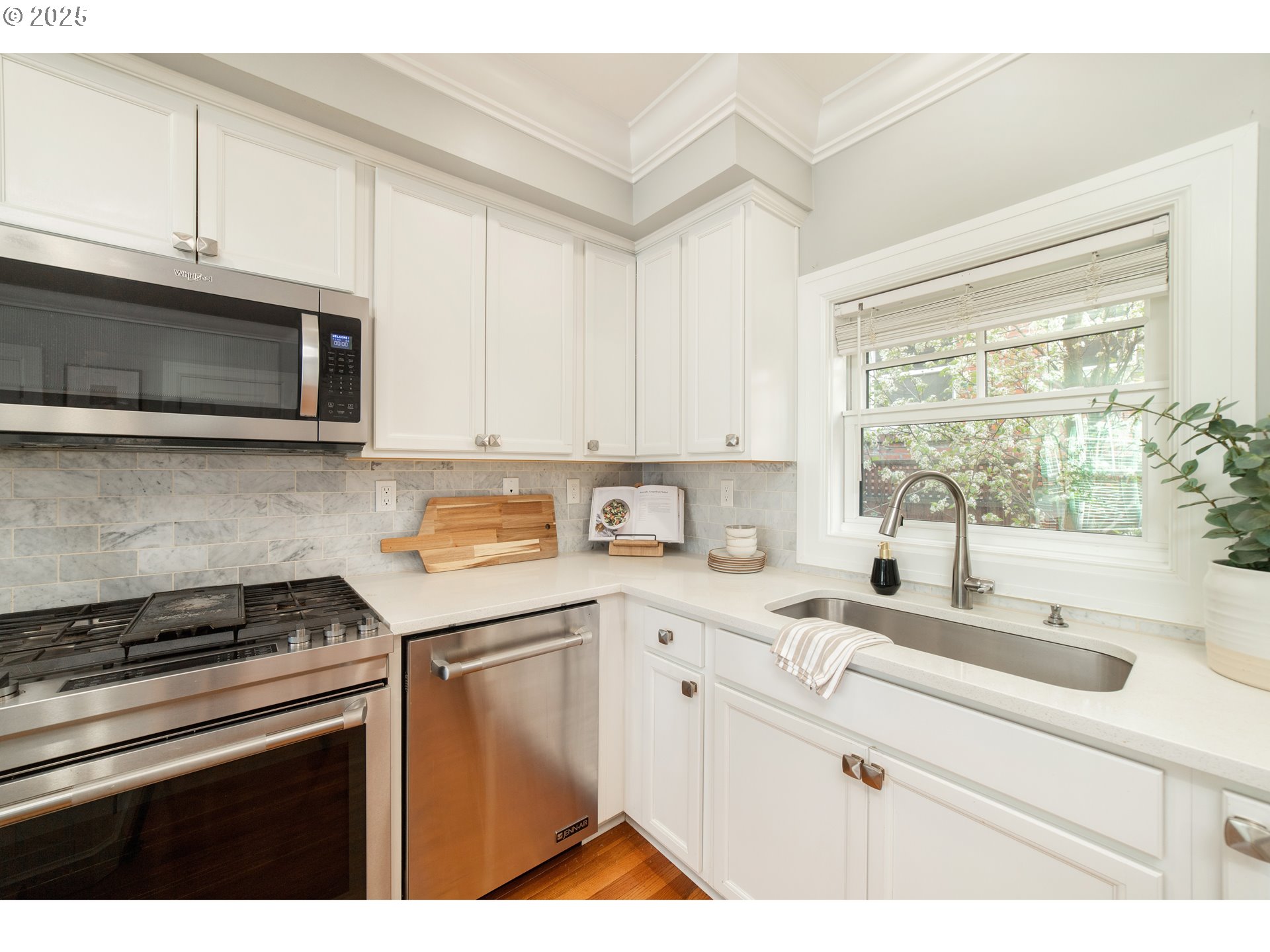 623 Northeast Randall Avenue Portland, OR 97232 - Photo 7 of 26 a kitchen with granite countertop white cabinets and white appliances