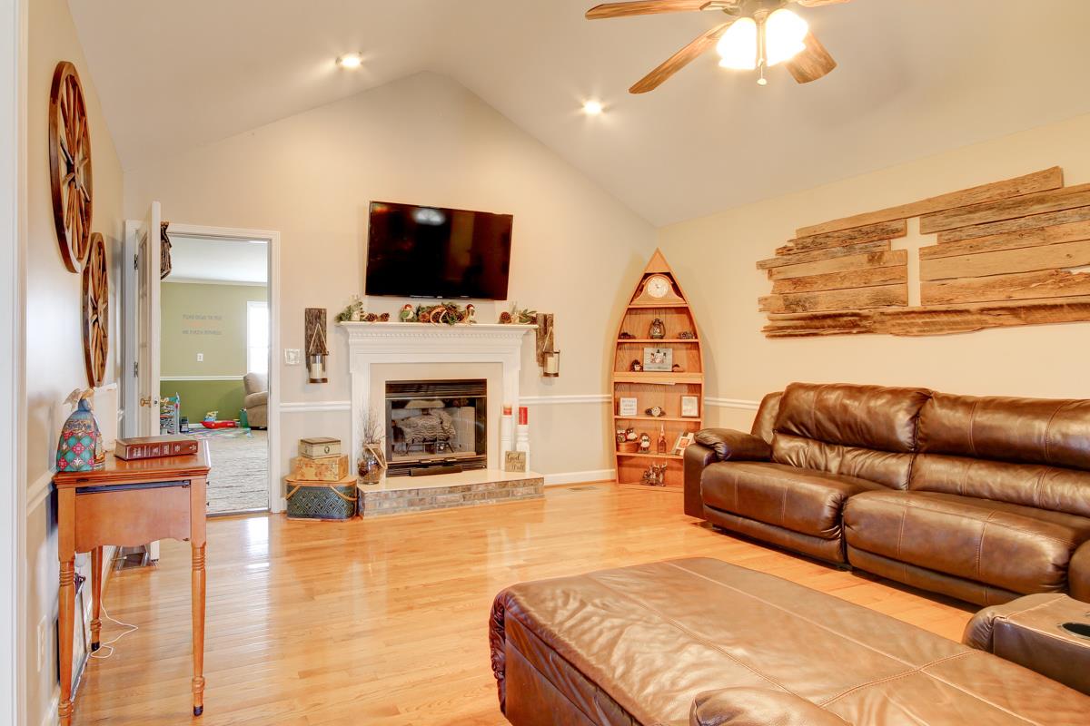 550 Hurricane Loop Tennessee Ridge, TN 37178 - Photo 2 of 18 a living room with furniture a flat screen tv and a fireplace