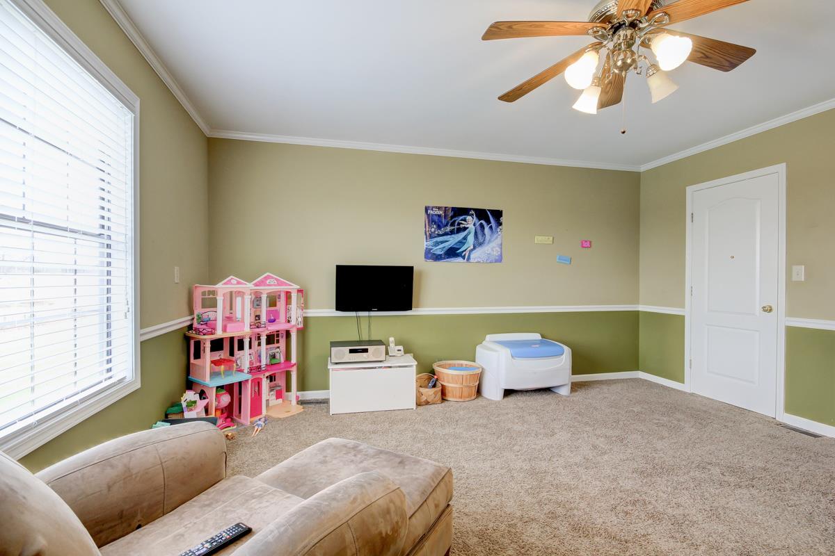 550 Hurricane Loop Tennessee Ridge, TN 37178 - Photo 12 of 18 a bedroom with furniture and a flat screen tv