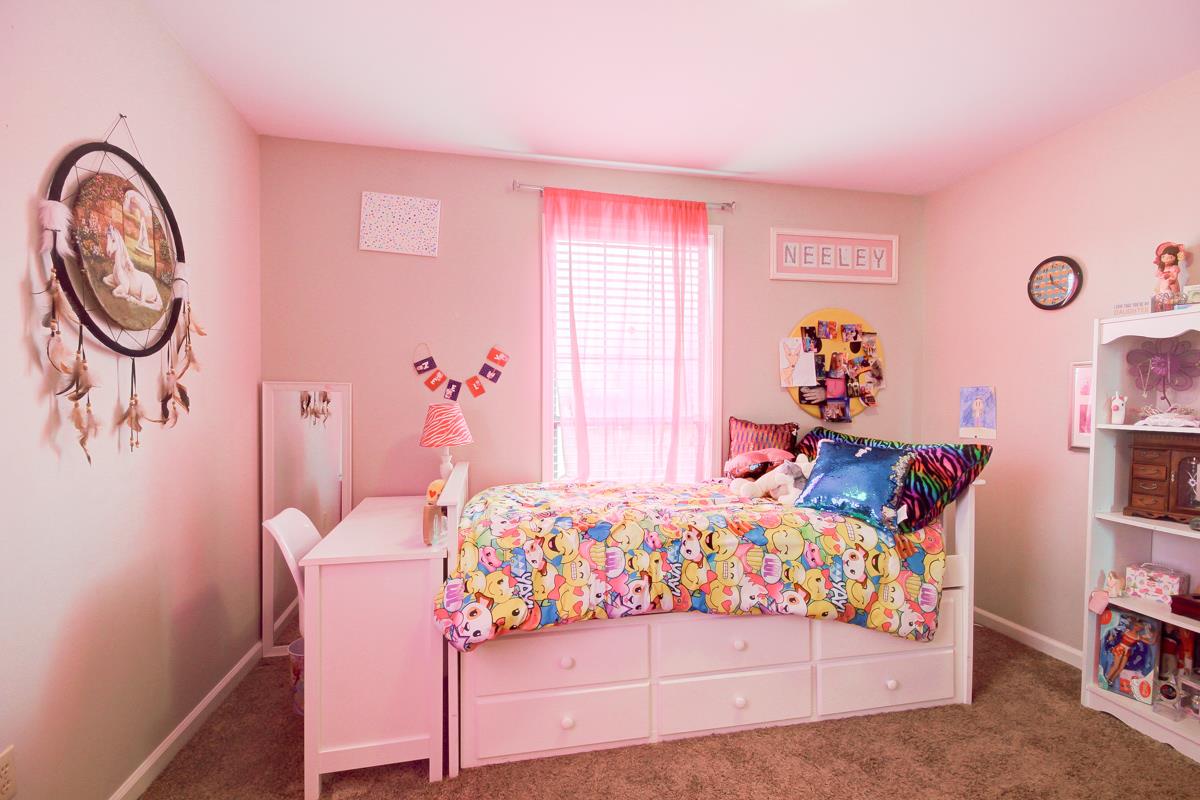 550 Hurricane Loop Tennessee Ridge, TN 37178 - Photo 15 of 18 a bedroom with a bed and a chandelier