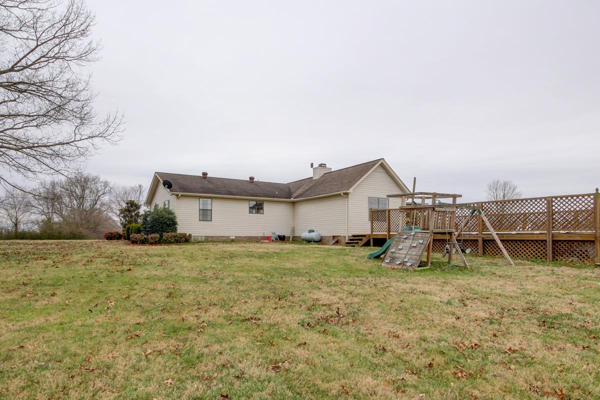 550 Hurricane Loop Tennessee Ridge, TN 37178 - Photo 17 of 18 a house with trees in front of it