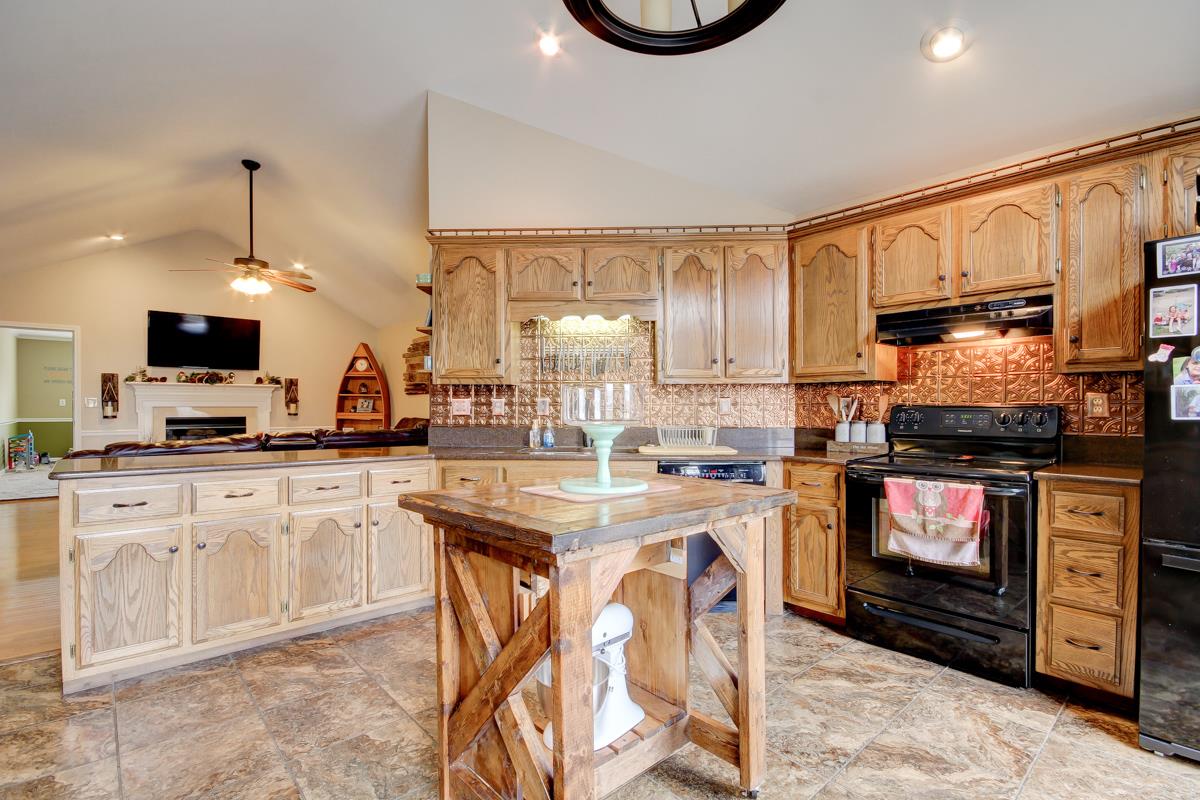 550 Hurricane Loop Tennessee Ridge, TN 37178 - Photo 8 of 18 a kitchen with stainless steel appliances a stove sink microwave and cabinets