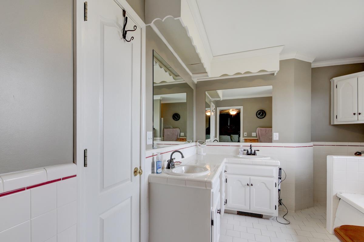550 Hurricane Loop Tennessee Ridge, TN 37178 - Photo 10 of 18 a bathroom with a double vanity sink and mirror