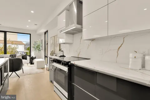 a kitchen with a sink a stove and cabinets