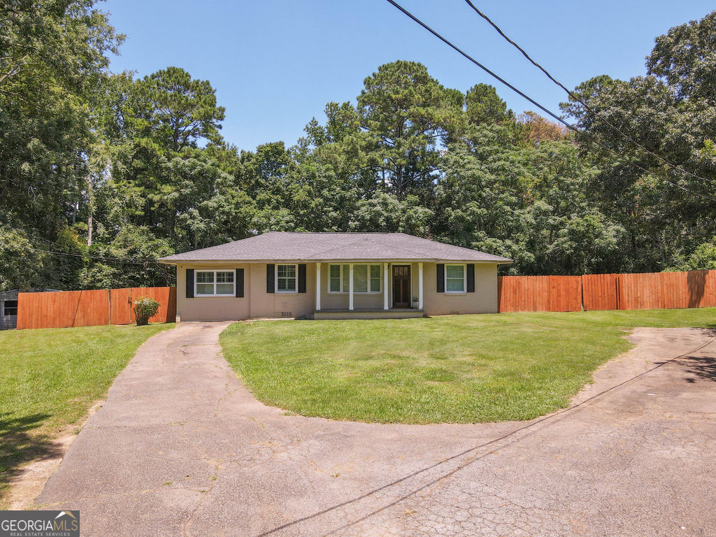 a view of a house with a backyard
