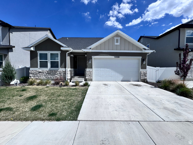 12339 Remy Road, Unit 422 Herriman, UT 84096 - Photo 1 of 36 View of front of house with a garage, concrete driveway, board and batten siding, and stone siding