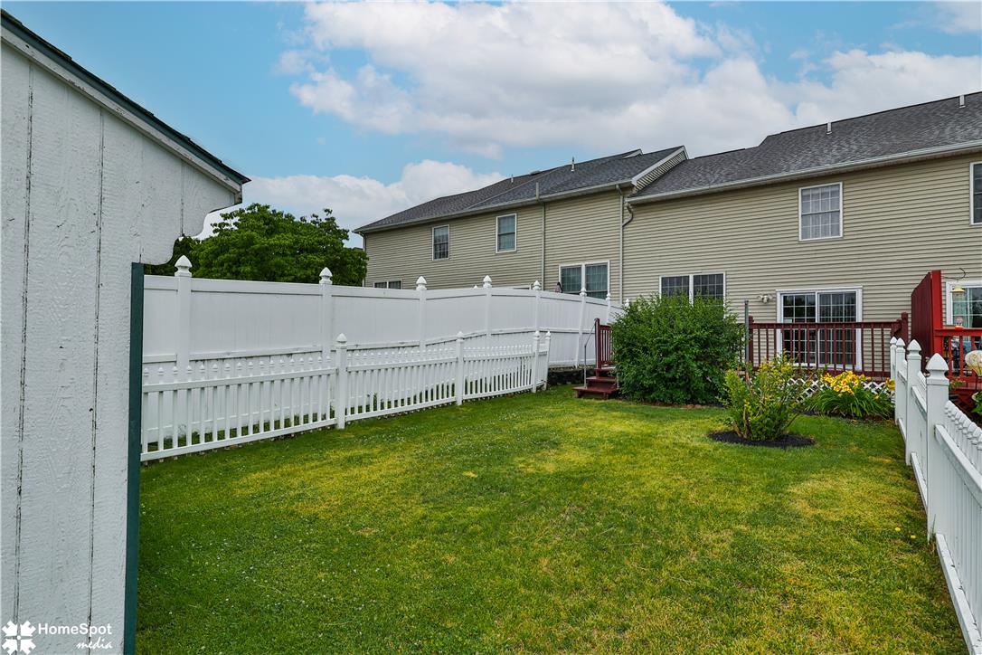 507 Howertown Road Northampton, PA 18067 - Photo 44 of 46 A neatly manicured lawn with a white picket fence, leading to a charming deck behind the residence.