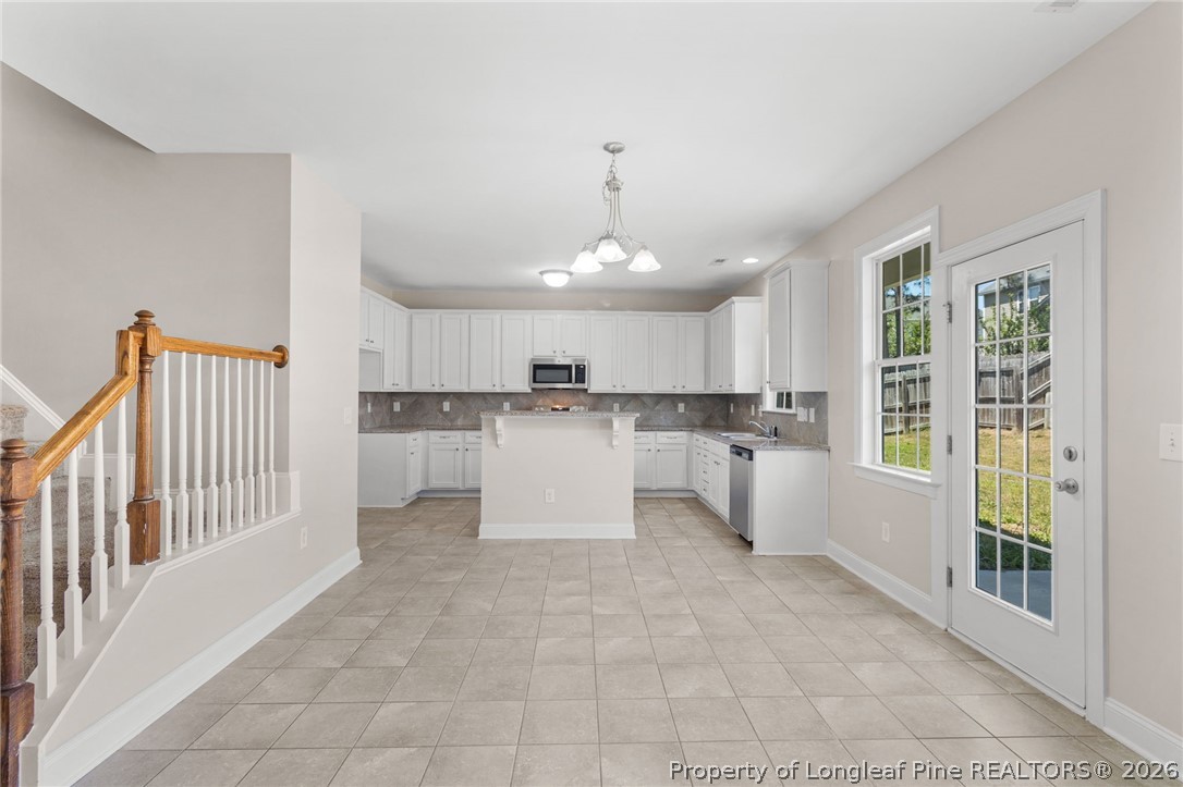50 Huzzas Circle Cameron, NC 28326 - Photo 11 of 39 a open kitchen with white cabinets and white appliances