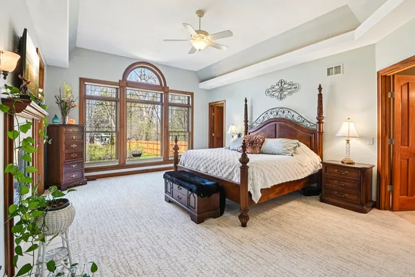 a bedroom with a bed and a television