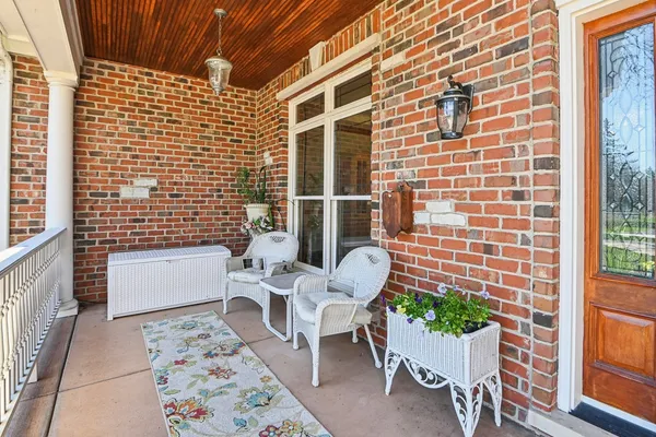 a balcony with a couch and a potted plant