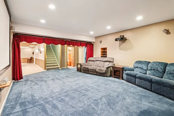 a living room with furniture and a pool table