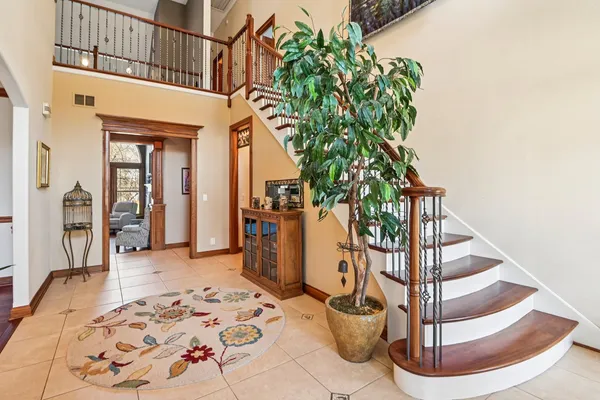 a living room with furniture a fireplace and a floor to ceiling window