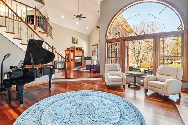 a living room with furniture a fireplace and wooden floor