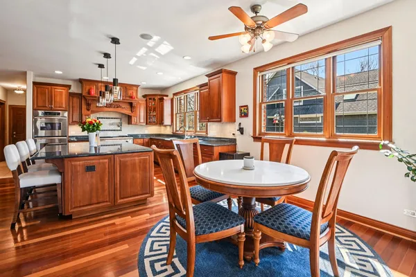a kitchen with stainless steel appliances granite countertop a kitchen island a stove and a sink