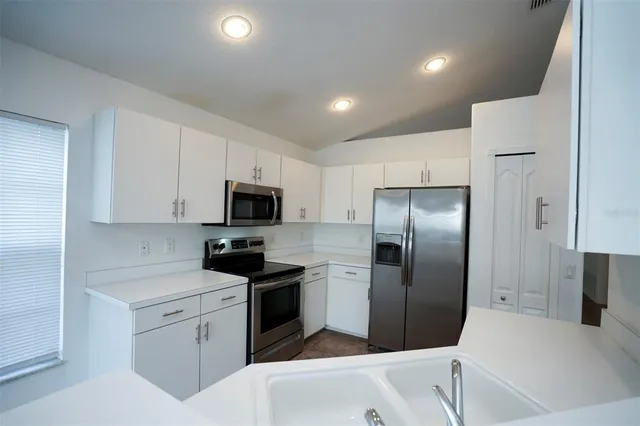 a kitchen with a stove microwave and sink