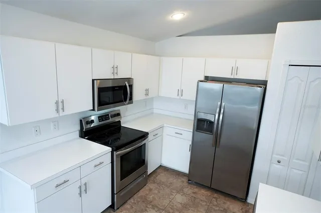 a kitchen with a refrigerator and a stove
