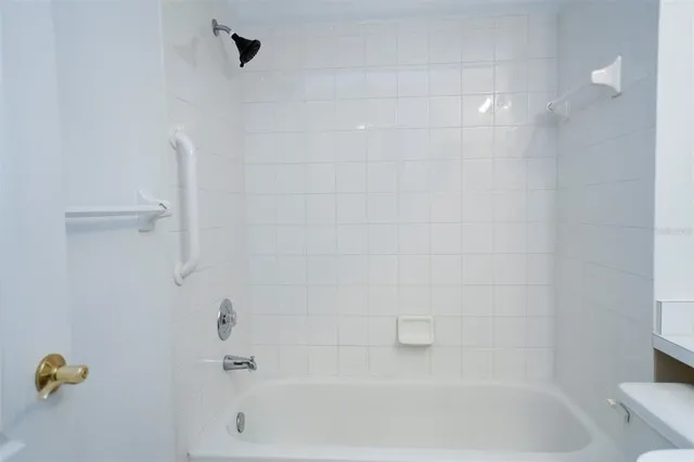 a bathroom with a sink a large mirror and a bathtub