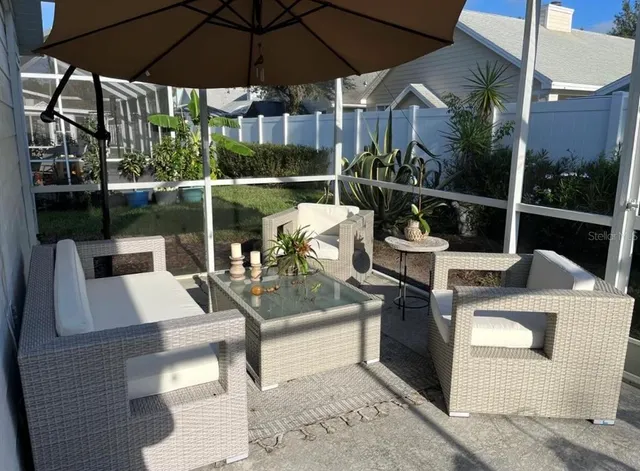 a balcony with furniture and a potted plant