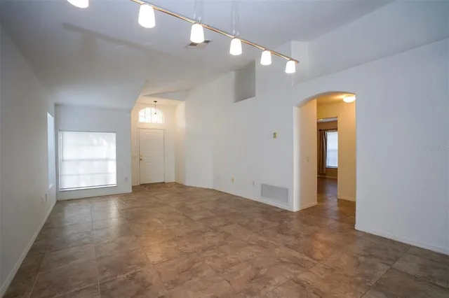 a living room with furniture a rug and a window