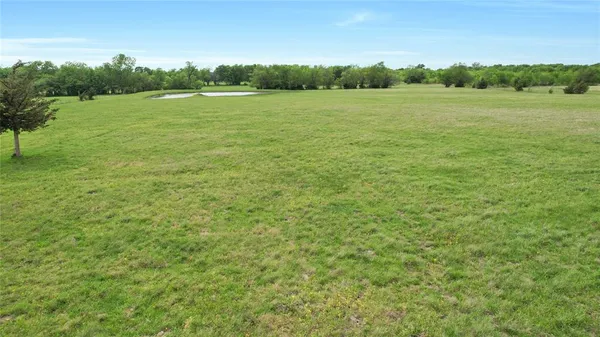 a view of a lake with a yard