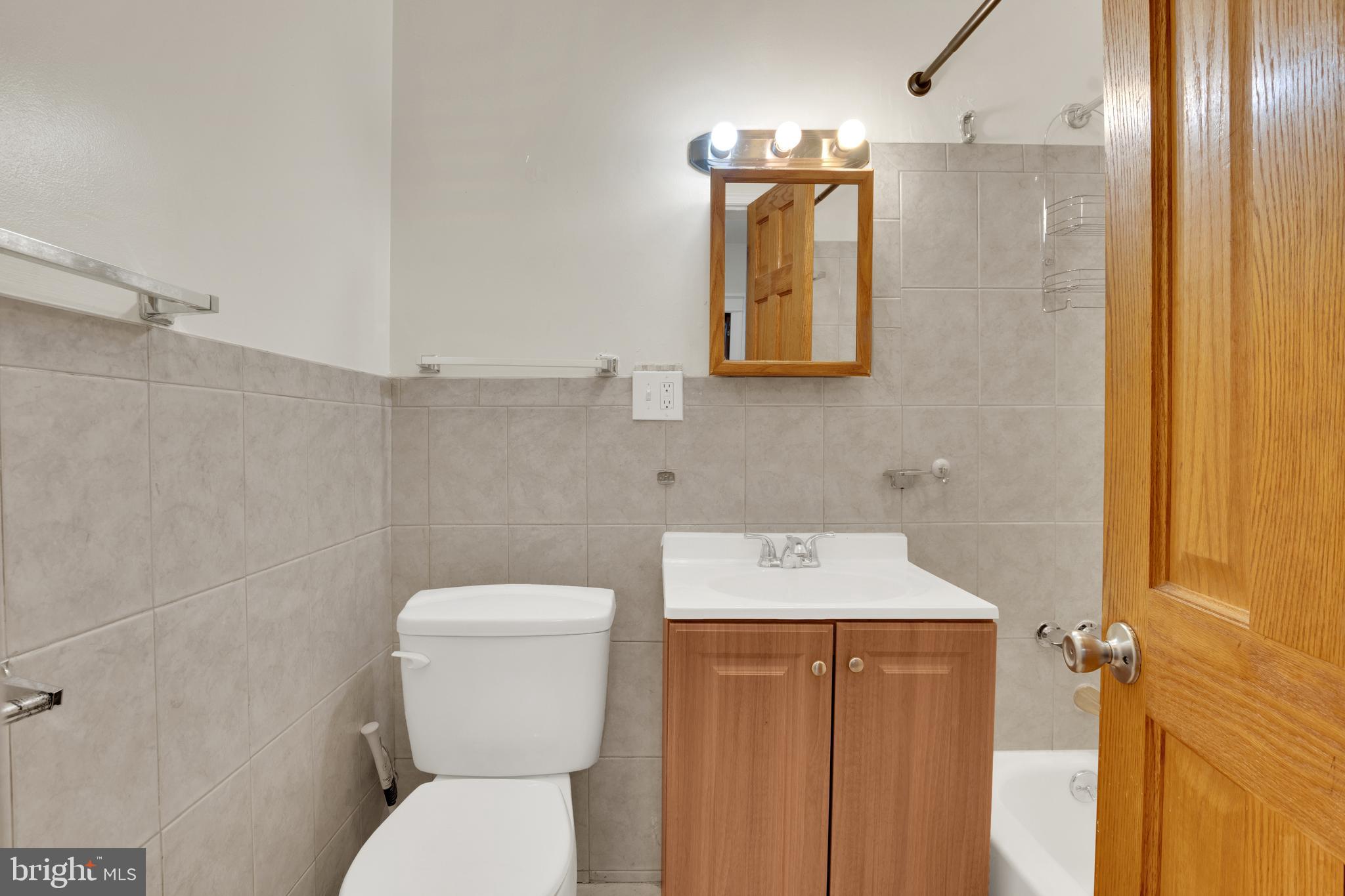 5731 9th Street Northwest Washington, DC 20011 - Photo 13 of 36 a bathroom with a toilet sink and mirror
