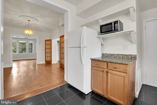 a kitchen with stainless steel appliances granite countertop a refrigerator and a stove