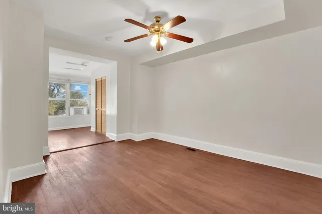 wooden floor in an empty room with a window