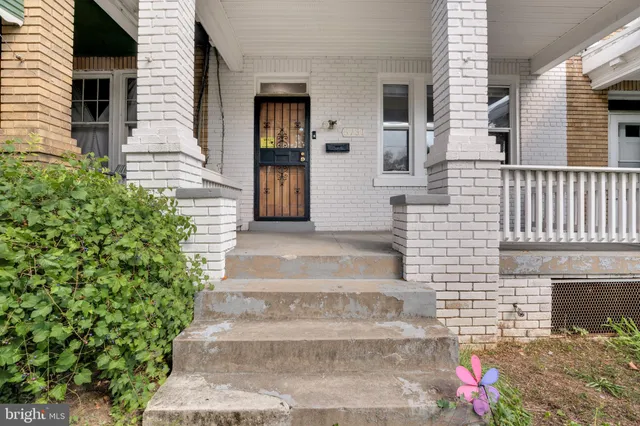 a front view of a house with plants