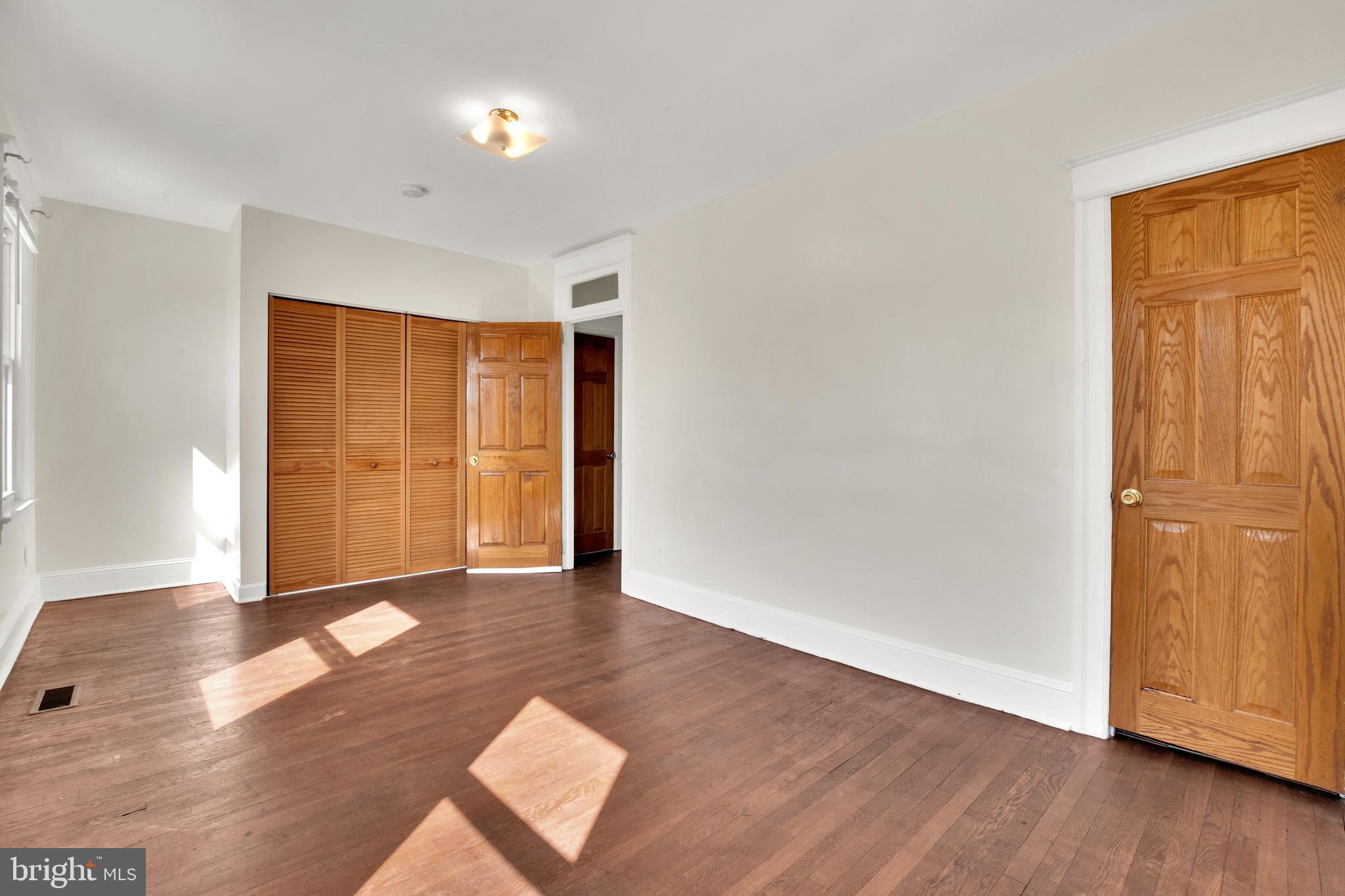 5731 9th Street Northwest Washington, DC 20011 - Photo 21 of 36 an empty room with wooden floor and windows
