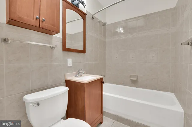 a bathroom with a toilet a sink and bathtub