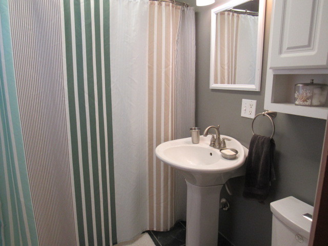 309 Cedar Drive Clinton, IL 61727 - Photo 15 of 20 a bathroom with a sink a mirror and a toilet