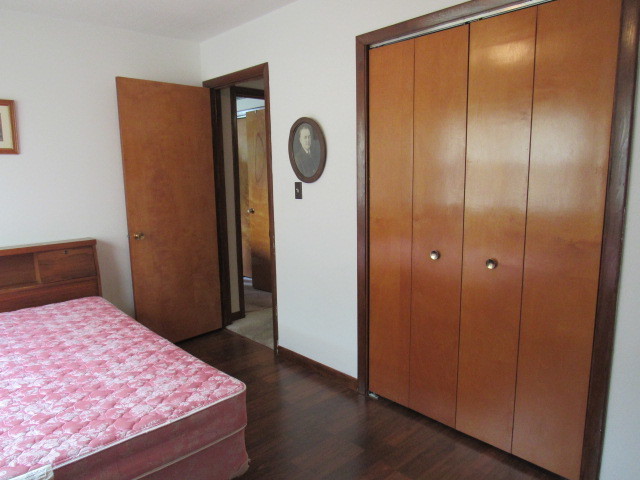 309 Cedar Drive Clinton, IL 61727 - Photo 19 of 20 a bedroom with a bed and a mirror