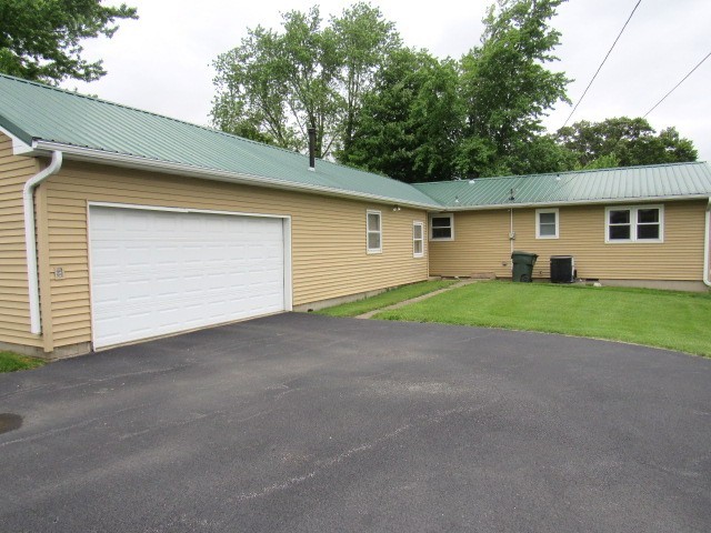 309 Cedar Drive Clinton, IL 61727 - Photo 2 of 20 a view of a house with a yard and garage