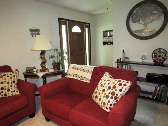 309 Cedar Drive Clinton, IL 61727 - Photo 6 of 20 a living room with furniture and a lamp
