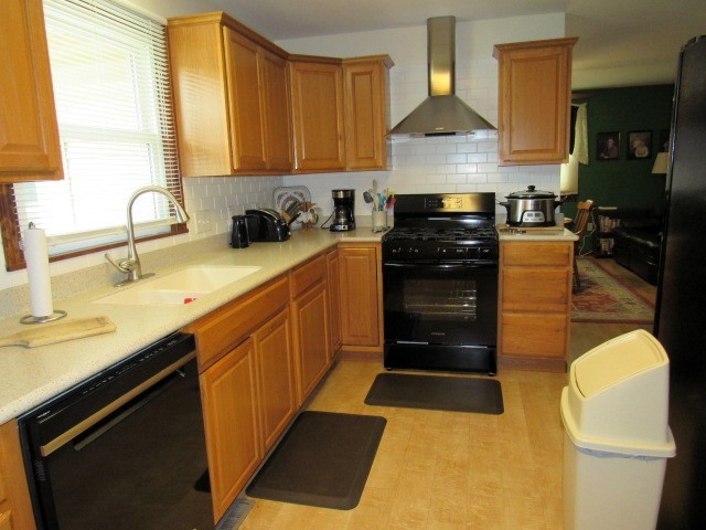 309 Cedar Drive Clinton, IL 61727 - Photo 7 of 20 a kitchen with stainless steel appliances granite countertop a stove a sink and a microwave